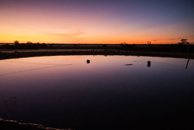 Scenic view of lake against romantic sky at sunset