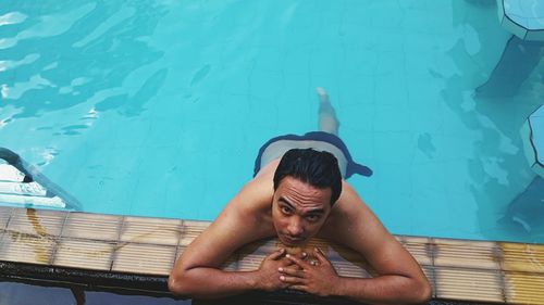 High angle portrait of shirtless man in swimming pool