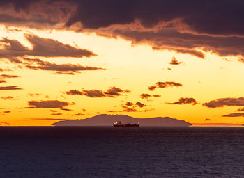 Scenic view of sea against orange sky