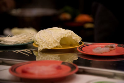 Close-up of vegetables in plates on table