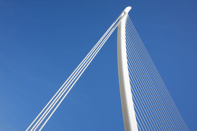 Low angle view of bridge against clear blue sky