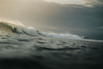 Surfer getting barreled at golden hour, surfphotography 