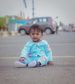 Portrait of cute boy standing on road