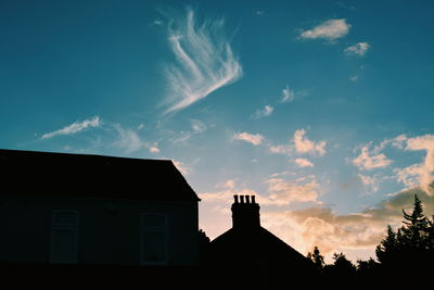 Low angle view of silhouette building against sky