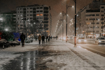 People walking on street at night