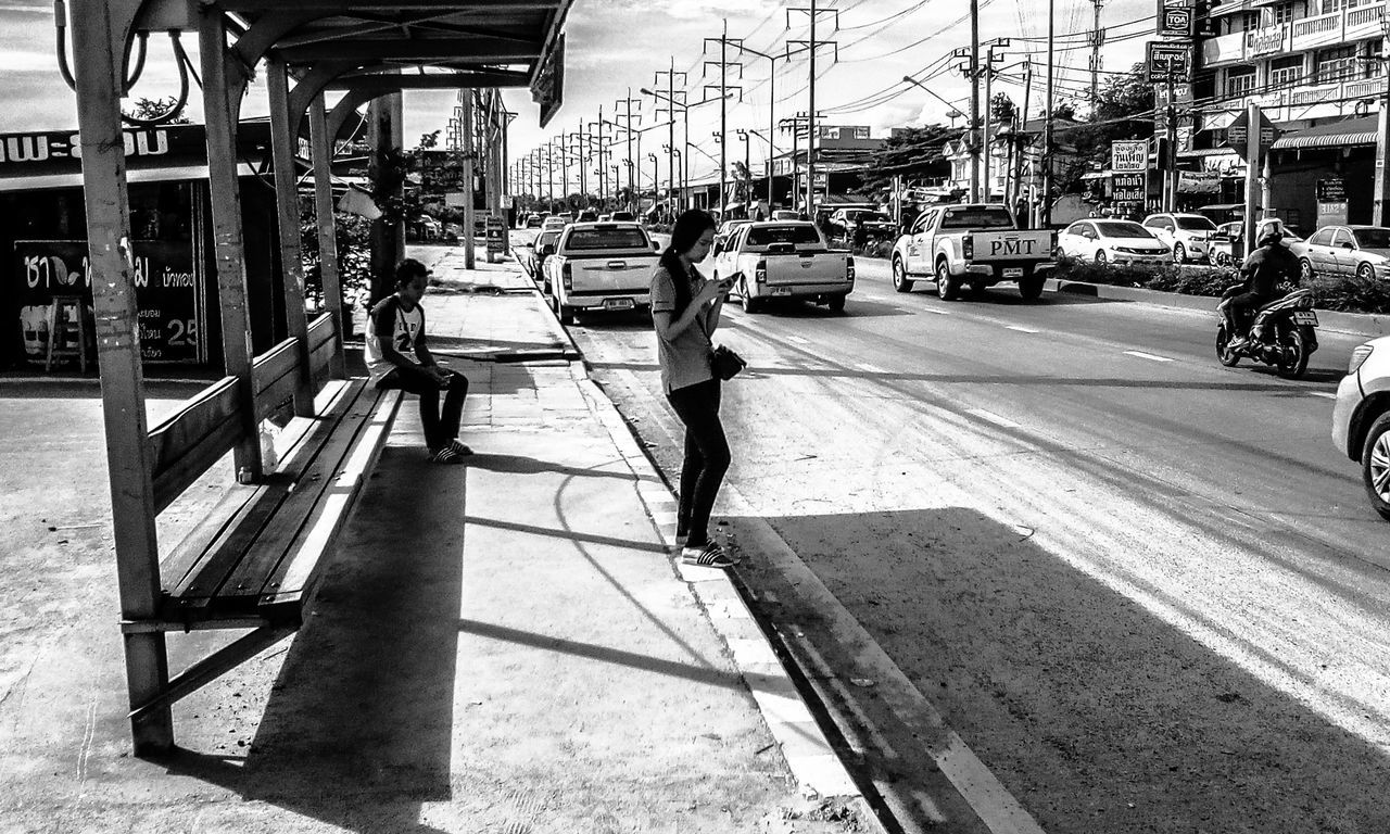 transportation, mode of transportation, land vehicle, city, motor vehicle, car, architecture, real people, street, built structure, one person, day, sunlight, building exterior, men, incidental people, lifestyles, road, nature, outdoors, waiting