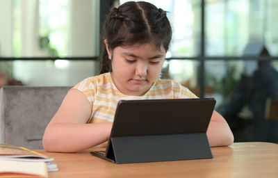 Businesswoman using laptop at office