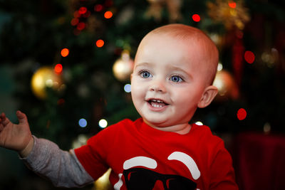 Portrait of smiling boy with christmas tree