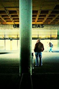 Woman standing by railing