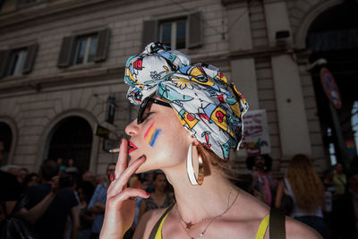 Portrait of woman with umbrella in city