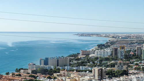 High angle view of buildings by sea against sky