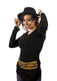 Portrait of young woman standing against white background