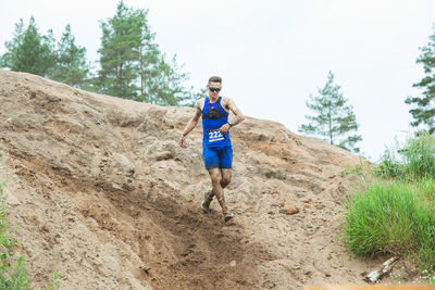 Portrait of man running on land