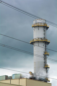 Low angle view of electricity pylon against sky