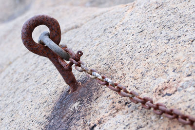 Close-up of rusty chain on wall