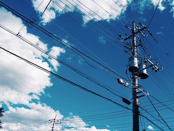 Low angle view of electricity pylon against sky