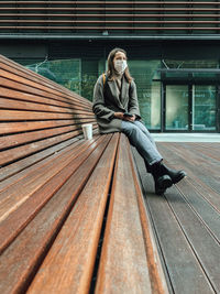 Full length of woman sitting outdoors