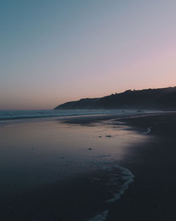 Scenic view of sea against clear sky during sunset