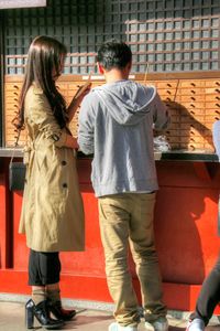 Rear view of two women walking outdoors