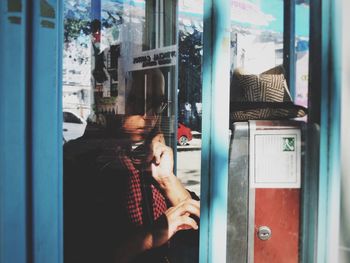 Man looking through window