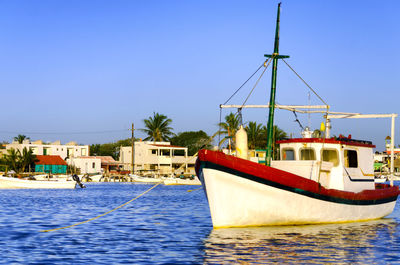 Boat in river against clear sky