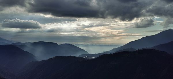Scenic view of silhouette mountains against sky during sunset