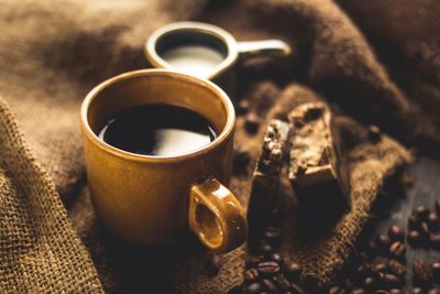 Close-up of coffee and beans on table