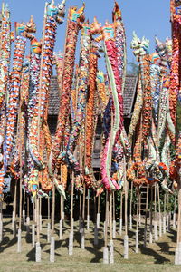 Low angle view of multi colored umbrellas hanging against sky