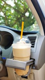 Disposable cup with iced coffee in car