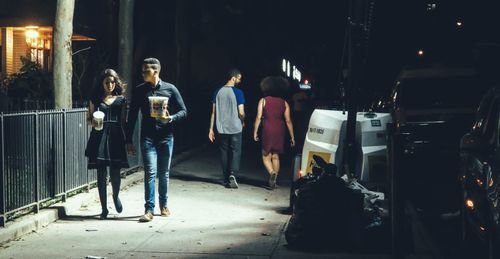 Full length of woman standing in illuminated room