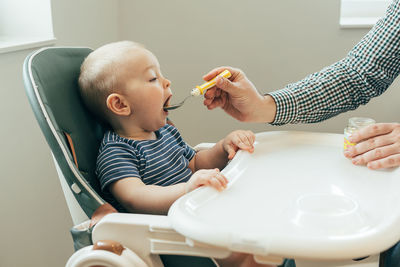 Cropped hand of doctor examining patient at home