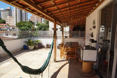Chairs and tables in swimming pool against building