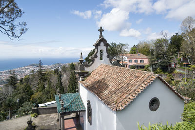 Panoramic view of building and trees against sky