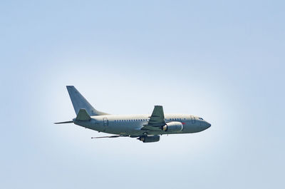 Low angle view of airplane flying against clear sky