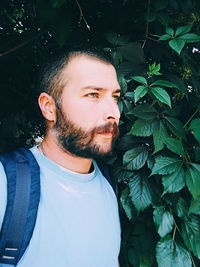 Portrait of man with green leaves