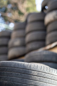 Old used rubber tires stacked with high piles. hazardous waste requiring recycling and disposal.