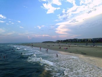 People on beach against sky