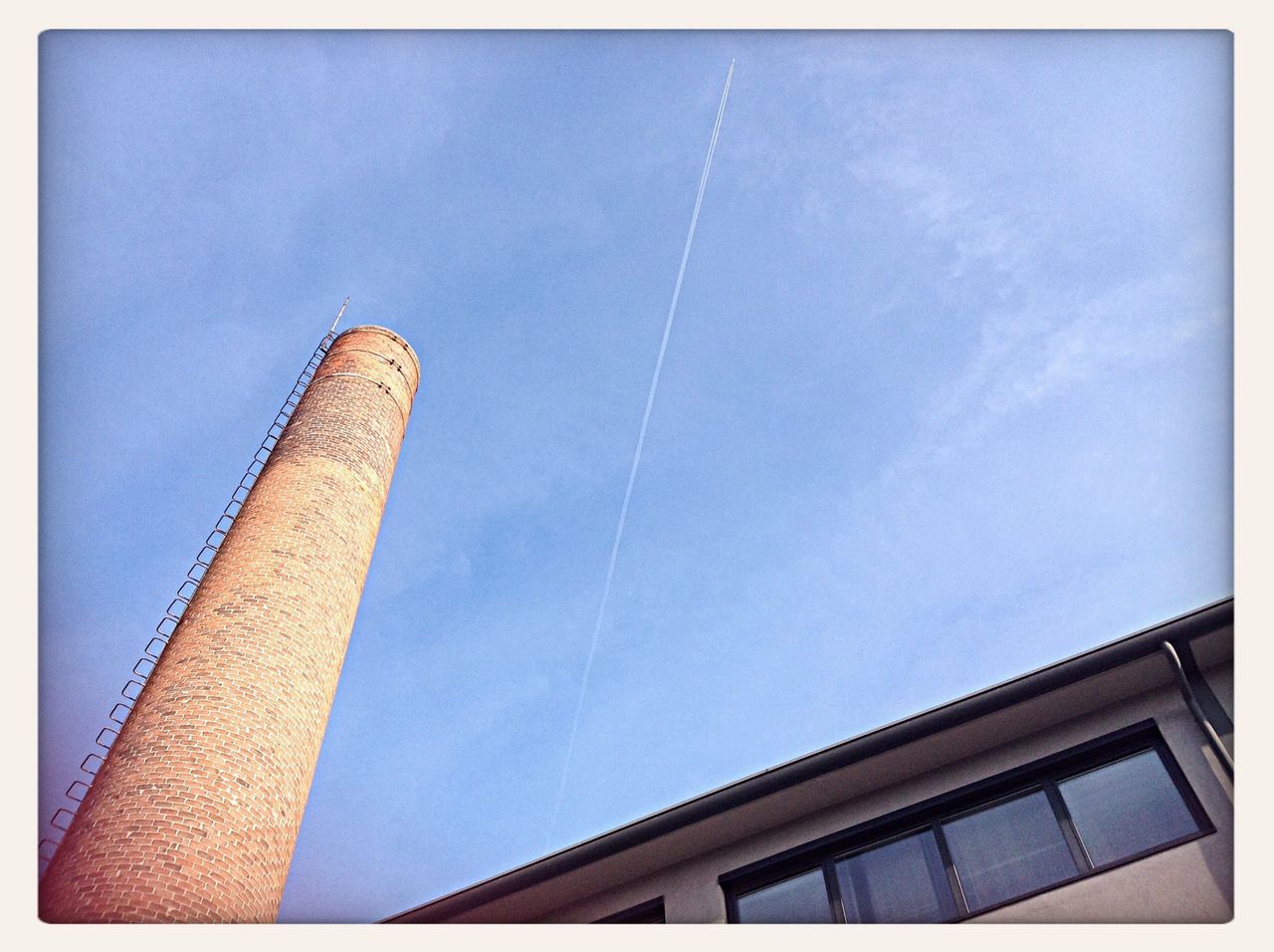 architecture, built structure, low angle view, building exterior, blue, transfer print, sky, tower, auto post production filter, tall - high, city, building, outdoors, skyscraper, day, no people, high section, tall, modern, office building