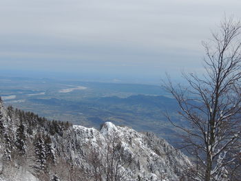 Scenic view of snow covered mountains against sky