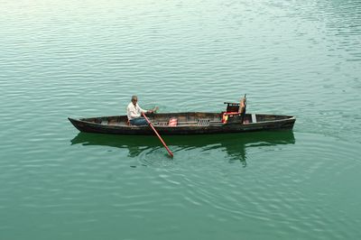 High angle view of man rowing boat in lake