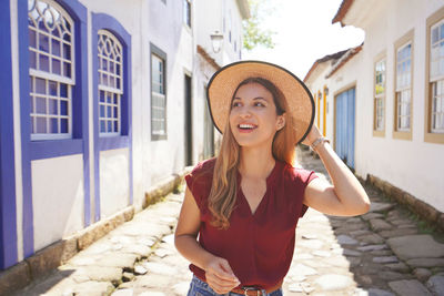 Fashionable happy smiling woman visiting latin american city. copy empty space for text.