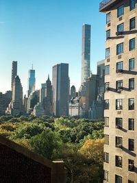 Modern buildings in city against clear sky