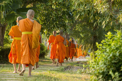 Rear view of monks walking in temple