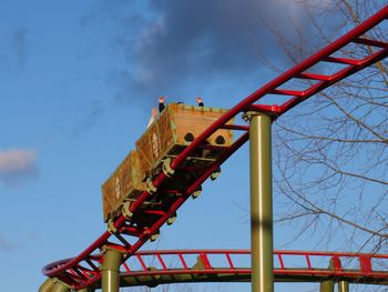 Low angle view of rollercoaster against sky