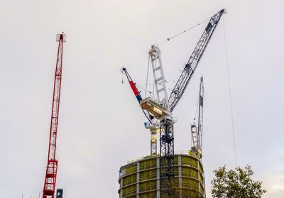 Low angle view of crane against sky