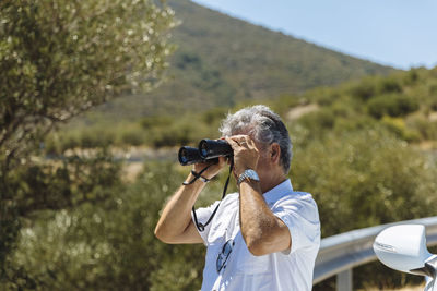 Man looking through binocular