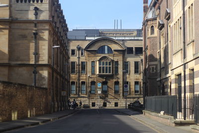 Street amidst buildings against sky