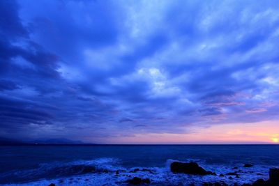 Scenic view of sea against cloudy sky