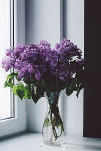 Close-up of flower vase on window sill at home