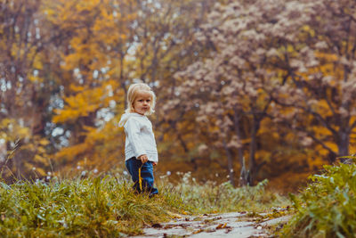 Full length of a man with autumn leaves